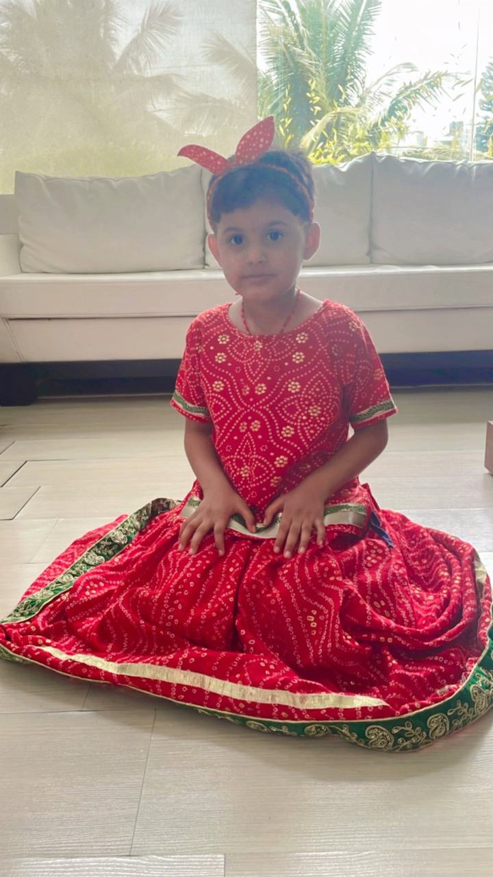 Girl posing in a red festive lehenga