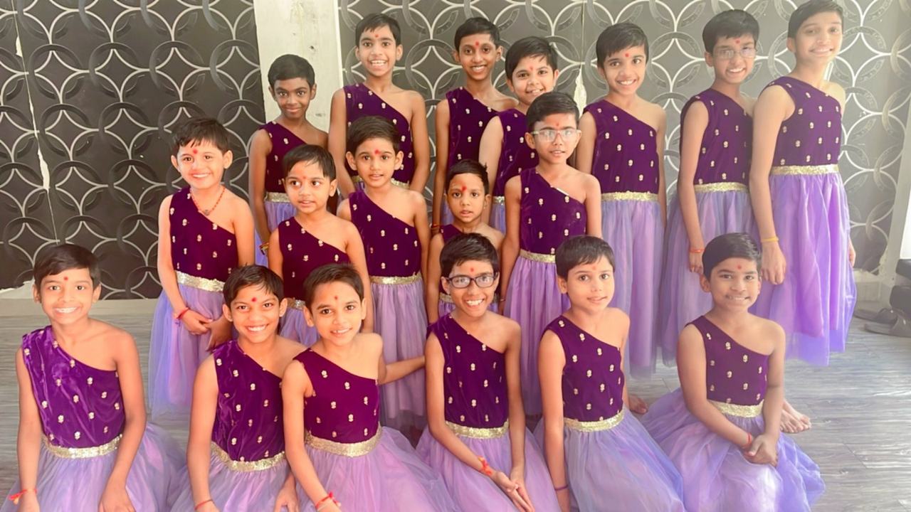 Dance group in matching purple costumes