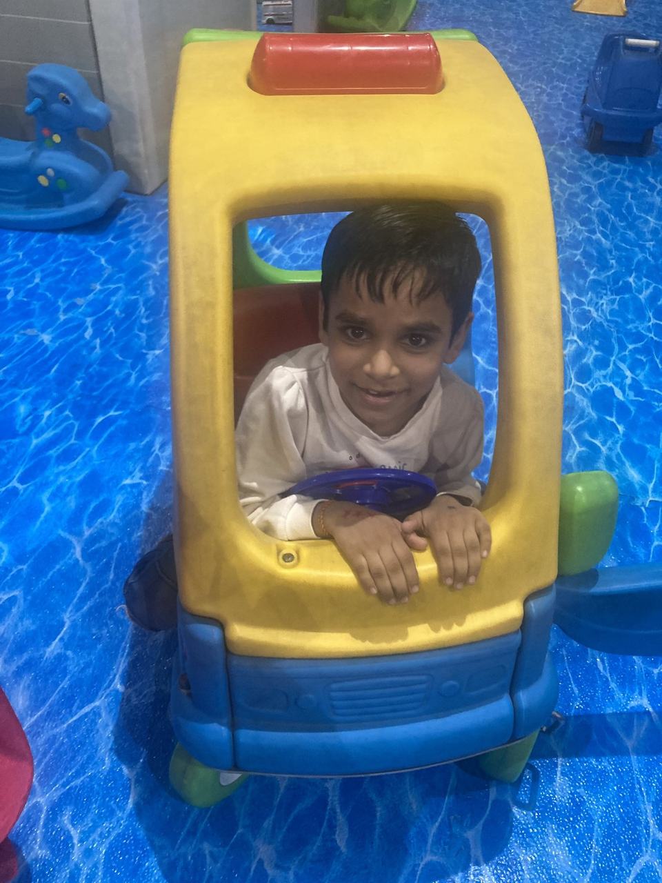 Child enjoying playtime in a toy car