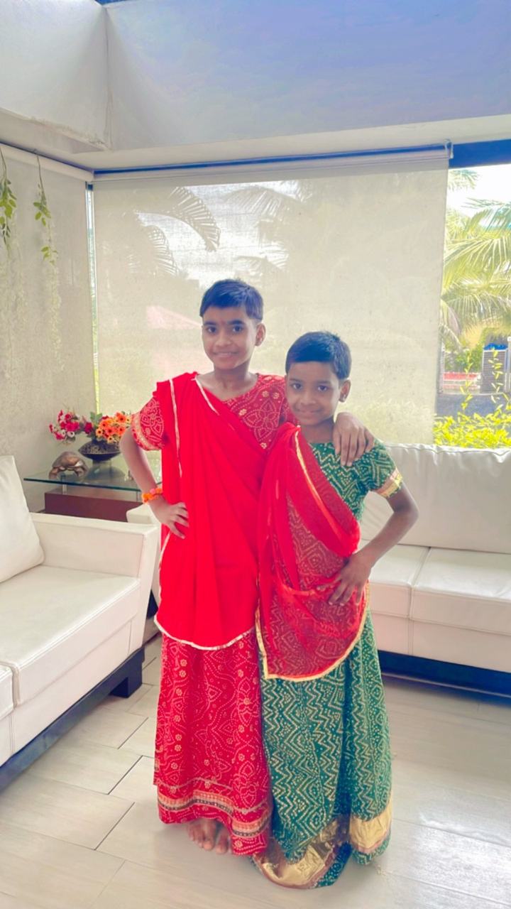 Two children in orange and green festival costumes