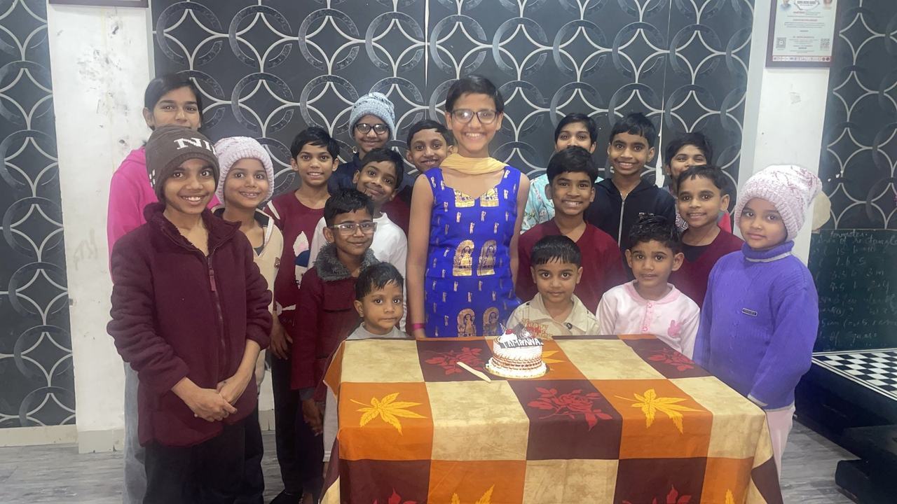 Children celebrating a birthday with a cake