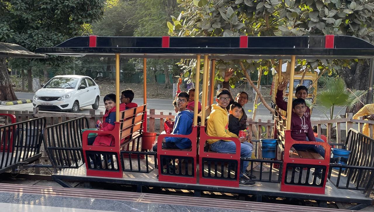 Children enjoying a toy train ride at an outing