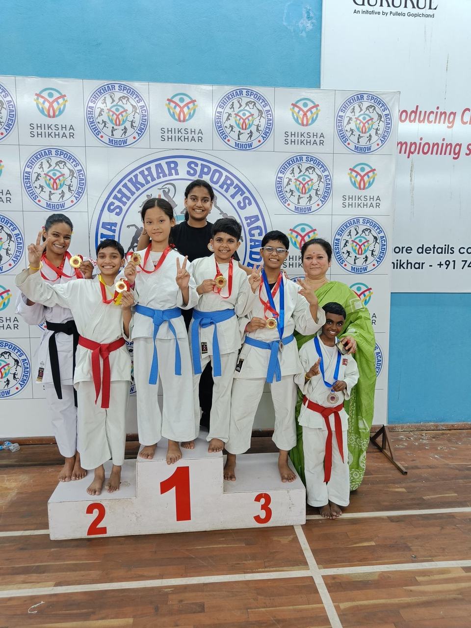 Children on a karate championship podium