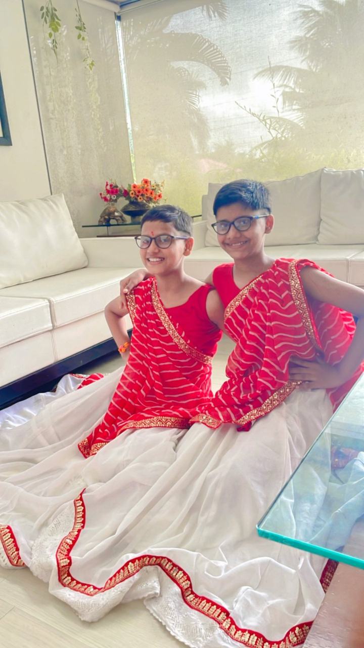 Two children posing in festive dance costumes