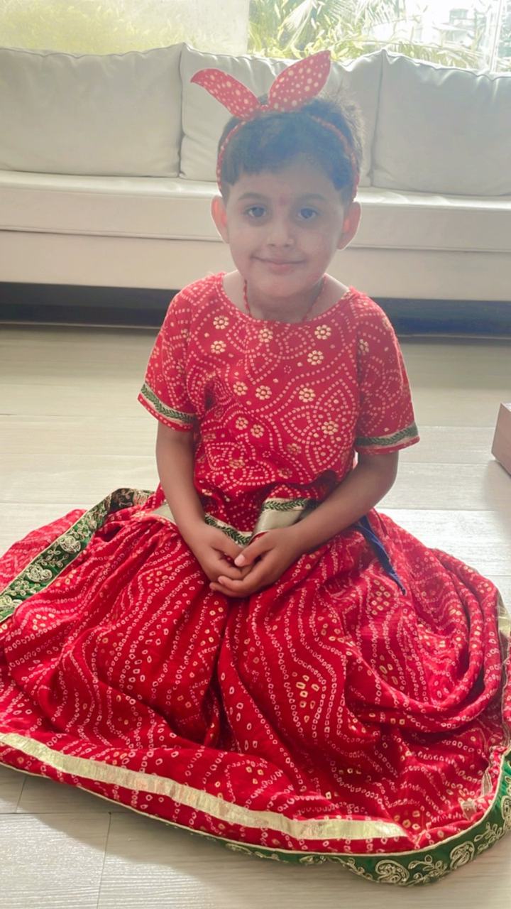 Girl posing in a red festive lehenga