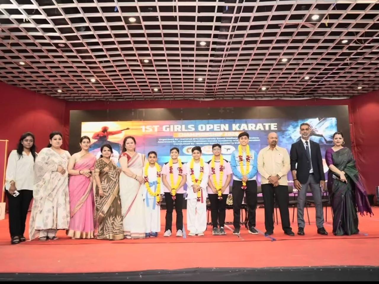 Dignitaries and medal winners on stage at the First Girls Open Karate Championship