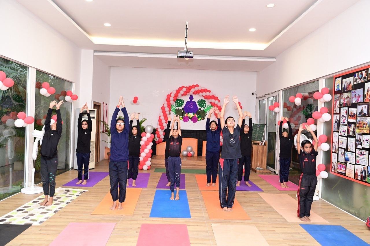 Children performing a dance under coloured lights
